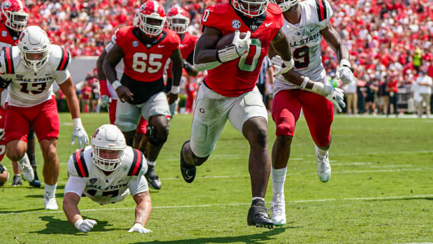 Sep 9, 2023; Athens, Georgia, USA; Georgia Bulldogs running back Roderick Robinson II (0) runs past Ball State Cardinals linebacker Keiont Newson (9) to score a touchdown against the Ball State Cardinals during the second half at Sanford Stadium.